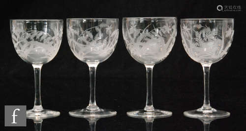 A set of four late Victorian clear crystal wine glasses with ovoid bowls engraved with fern,