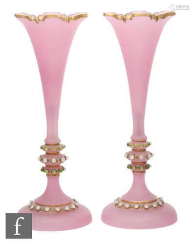 A pair of late 19th Century continental glass vases of footed trumpet form in pink opaline with