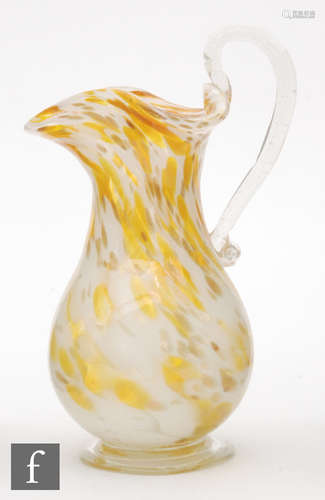 An early 20th Century continental glass jug of footed baluster form with wide wave rim and applied