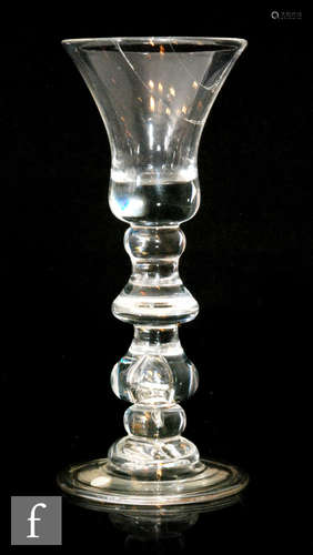 An early 18th Century baluster drinking glass circa 1715,