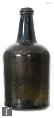 A large 18th Century olive green glass wine bottle of mallet form with applied lip, height 37cm.