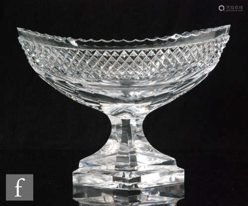 A late Georgian Irish table centre bowl of boat shape with scalloped rim above a straberry diamond