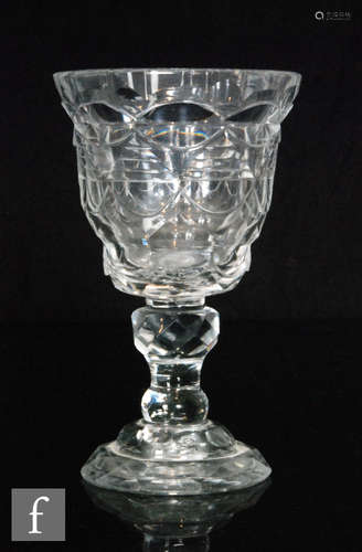 A late 18th Century goblet with a round funnel bowl heavily cut with repeat lozenges and flats