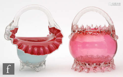 A late 19th Century Stourbridge ruby glass posy basket of footed ovoid form with applied clear