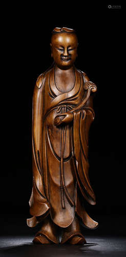 A HUANGYANG WOOD CHARACTER ORNAMENT