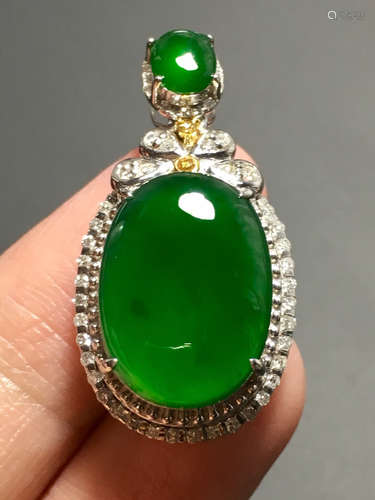 AN ICE SUN GREEN JADEITE EGG PENDANT