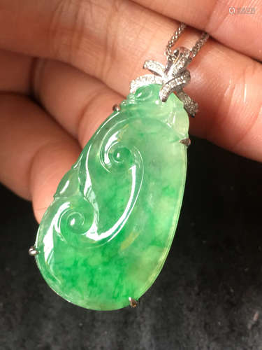 AN ICE GREEN JADEITE RUYI PENDANT