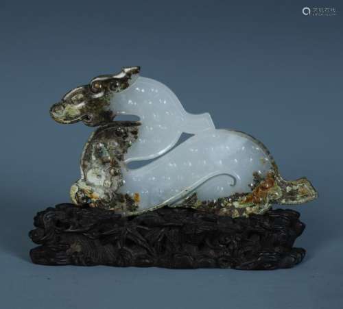 A Finely Carved Chinese White and Russet Jade Animal