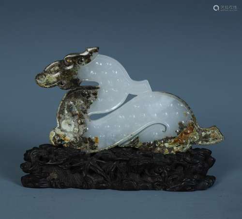 A Finely Carved Chinese White and Russet Jade Animal