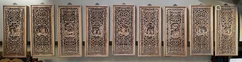 A SET OF NINE CAMPHOR WOOD CARVED WINDOW PANELS