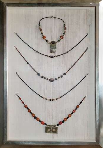 A FINE SET OF NECKLACES WITH FRAME