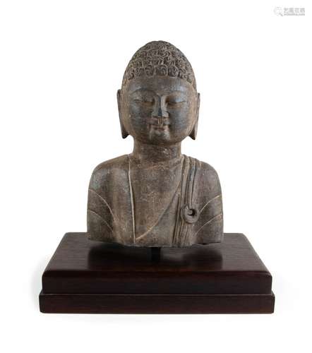 A CARVED STONE HEAD OF BUDDHA