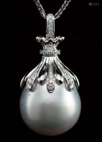A LARGE PEARL PENDANT ON A NECKLACE