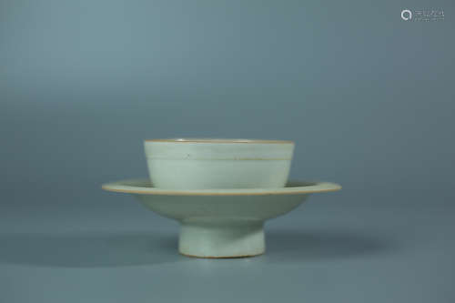 A HUTIAN KILN CUP ON A PLATE