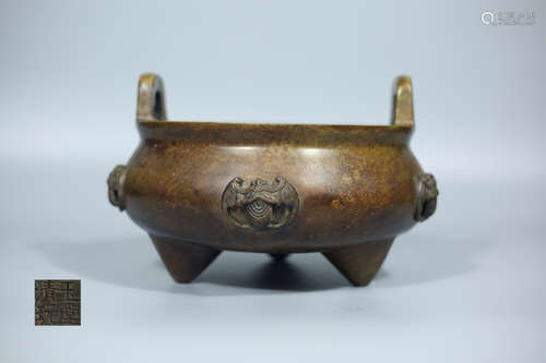 A BRONZE TRI-LEG CENSER