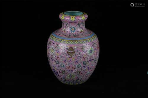 A CHINESE PINK-GROUND FAMILLE ROSE CANDLE VASE WITH