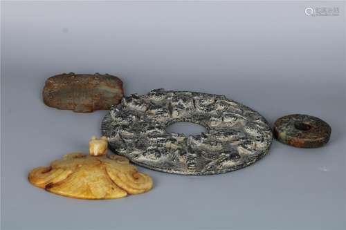 A GROUP OF FOUR CHINESE JADE DISC BIS, WARRING STATE