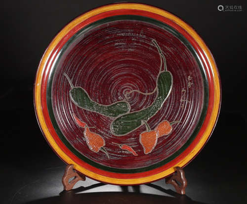 A WOOD WITH LACQUER PAINTED PLATE