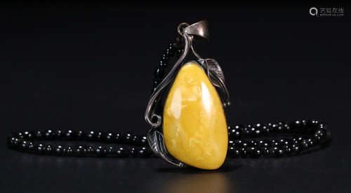 A BEESWAX WITH SILVER DECORATED PENDANT