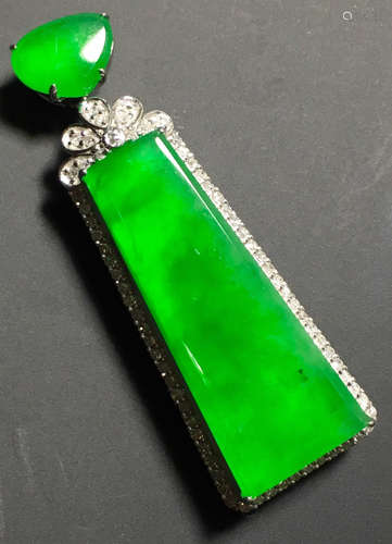 A GREEN JADEITE CARVED PENDANT, TYPE A