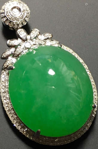 A GREEN JADEITE CARVED CIRCLE PENDANT, TYPE A