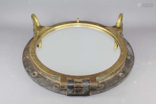 An Original Brass Ship's Port Hole (now mirrored) for decorative purposes, approx 58 cms d