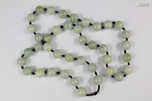 A String of Chinese Jade Beads, individually knotted, approx 70 cms l