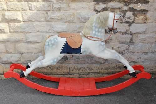 A Vintage Rocking Horse: the rocking horse having leather reins and saddle, the rocking unit measures approx 210 x 40