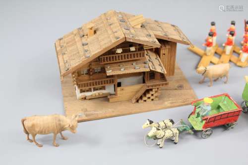 A Fine Wood Carved Model of a Swiss Chalet, complete with a small collection of farm animals and people