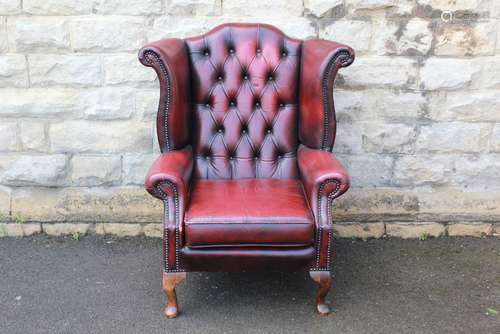 A Claret Leather Button Back Wing-back Chair in the Chesterfield style