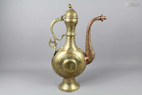 A 19th Century Islamic Bronze and Copper Ewer, The ewer with copper spout and decorative zoo-form handle, approx 42 cms, the entire body and foot incised with foliate decoration