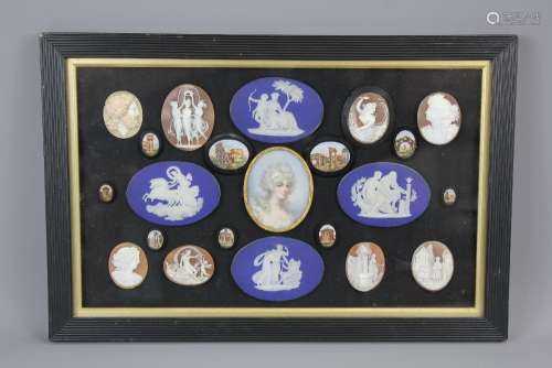 A Victorian Framed and Glazed Vignette, comprising of four Wedgwood cobalt Jasper-ware ovals with classic themes in white relief approx 7 x 7 cms, with two Italian mosaic ovals and seven smaller ovals depicting Italianate architecture together with eight shell cameos and centered by a oval portrait miniature depicting a lady, approx 5