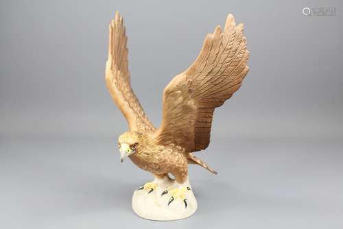 A Beswick Figure of a Golden Eagle: the eagle with wings outstretched measures approx 26 cms, impressed marks to base nr 2062 