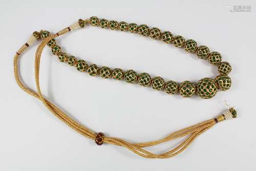 A String of Indian Glass Beads, heightened with gilt, approx 94 cms