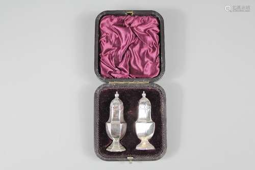 A Pair of Silver Pepper Pots, Chester hallmark, dated 1895, mm John and William Deakin, in the original leather box