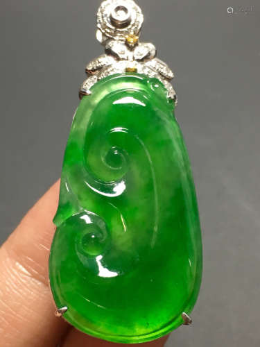 AN ICY ZHENGYANG GREEN JADEIET PENDANT IN RUYI SHAPED