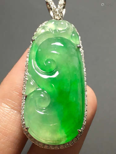 AN ICY ZHENGYANG GREEN JADEIET PENDANT IN RUYI SHAPED