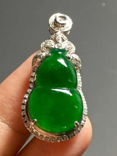 AN ICY GREEN JADEITE PENDANT IN GOURD SHAPED