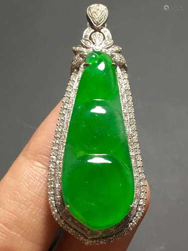 AN ICY ZHENGYANG GREEN JADEIET PENDANT IN BEANS CARVED