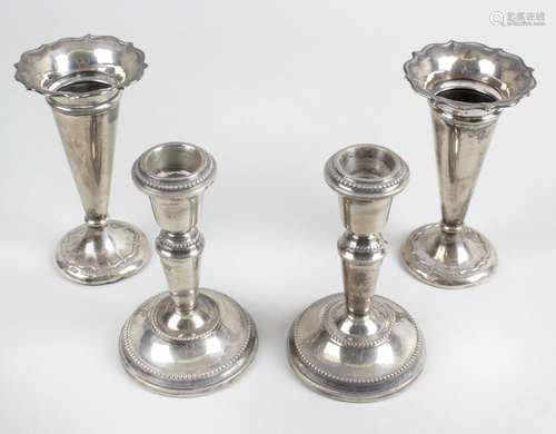 A pair of early George V small silver vases,