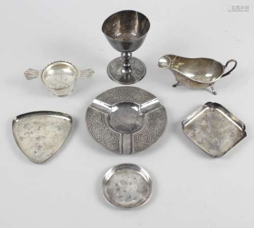 A selection of small silver items to include a 1930's twin-handled tea strainer on circular footed