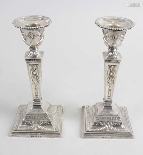 A pair of modern silver mounted candlesticks,