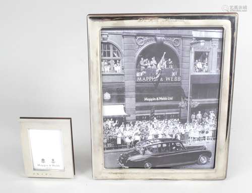 A modern matched pair of small silver mounted photograph frames,