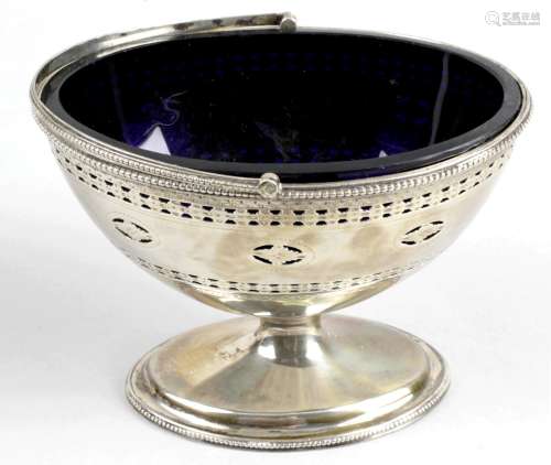A George III silver sugar basket with blue glass liner,
