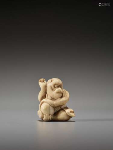 AN UNUSUAL IVORY NETSUKE OF A MONKEY WITH PEACHES