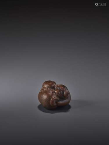 A FINE WOOD NETSUKE OF TWO PLAYING PUPPIES BY SHIR…
