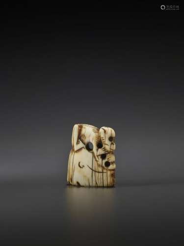 A CHINESE IVORY TOGGLE OF A MONKEY ON A ROCK