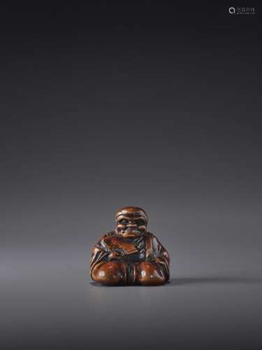 A FINE WOOD NETSUKE OF A NOH ACTOR