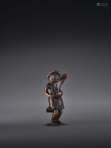 AN UNUSUAL AND RARE WOOD NETSUKE OF A FOREIGN ENTE…