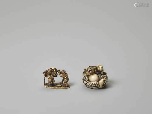 TWO IVORY NETSUKE OF A TANUKI WITH RABBIT